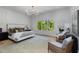 Cozy main bedroom featuring a large window view, comfortable furniture, and soft lighting at 3290 Dunlop Ne Ct, Atlanta, GA 30319