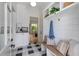 Mudroom with patterned tile flooring, storage bench, coat hooks, and lots of natural light at 3290 Dunlop Ne Ct, Atlanta, GA 30319