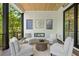 Cozy patio features four chairs and a table by the dark wood deck with views of green trees at 3290 Dunlop Ne Ct, Atlanta, GA 30319