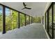 Expansive covered patio with ceiling fans, and beautiful views overlooking the serene, wooded surroundings at 3290 Dunlop Ne Ct, Atlanta, GA 30319