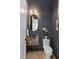 Stylish powder room featuring unique wallpaper, marble sink, and modern lighting fixtures at 3290 Dunlop Ne Ct, Atlanta, GA 30319