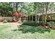 Spacious backyard with green grass, mature trees, and a screened porch, ideal for entertaining at 1280 Berkeley Rd, Avondale Estates, GA 30002