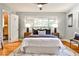 Bedroom featuring a large window, hardwood floors, and ensuite bathroom access at 1280 Berkeley Rd, Avondale Estates, GA 30002