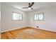 Bright bedroom featuring hardwood floors, ceiling fan, and natural light from the large windows at 1280 Berkeley Rd, Avondale Estates, GA 30002