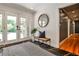 Inviting foyer with stone tile, complemented by a stylish bench and bright view through glass doors at 1280 Berkeley Rd, Avondale Estates, GA 30002