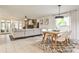 Open-concept living and dining area with stylish decor, stone fireplace, and ample natural light at 1280 Berkeley Rd, Avondale Estates, GA 30002