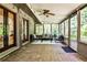 Relaxing sunroom with brick floors, ceiling fan, and multiple windows offering views of the backyard at 1280 Berkeley Rd, Avondale Estates, GA 30002