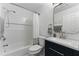 This full bathroom features a shower-tub combo, white subway tiles, modern fixtures, and a storage vanity at 2154 Windstream Sw Way, Marietta, GA 30060