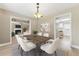 Cozy dining room boasts a modern light fixture, a table with seating, and an open layout at 2154 Windstream Sw Way, Marietta, GA 30060