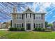 Charming two-story home with gray siding, black shutters, manicured lawn, and a welcoming front entrance at 2154 Windstream Sw Way, Marietta, GA 30060