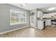 A sunlit kitchen with backyard views through large windows, stainless appliances, and white cabinets at 2154 Windstream Sw Way, Marietta, GA 30060