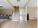 Open-concept living space with hardwood flooring, staircase, sofa, and neutral color scheme at 2154 Windstream Sw Way, Marietta, GA 30060
