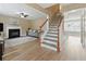 Inviting living area with fireplace, staircase, hardwood floors, neutral paint, and lots of natural light at 2154 Windstream Sw Way, Marietta, GA 30060