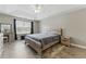 Spacious main bedroom with a king bed, tray ceiling, wood-look floors, ensuite, and lots of natural light at 2154 Windstream Sw Way, Marietta, GA 30060