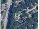 An aerial view of a home nestled within a lush, green, wooded neighborhood at 2461 Peregrine Trl, Suwanee, GA 30024