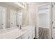 Bright bathroom featuring a double sink vanity with white cabinets and a large mirror at 2461 Peregrine Trl, Suwanee, GA 30024