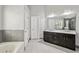 Bathroom featuring double sinks, a large mirror, separate shower, and a soaking tub at 2461 Peregrine Trl, Suwanee, GA 30024