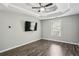 Bright, sunny bedroom with hardwood floors, trey ceiling and a ceiling fan at 2461 Peregrine Trl, Suwanee, GA 30024