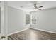 Neutral bedroom features hardwood floors, a ceiling fan, and a window at 2461 Peregrine Trl, Suwanee, GA 30024