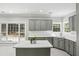 Beautiful kitchen with stainless steel appliances, tile floors, an island, and shaker cabinets at 2461 Peregrine Trl, Suwanee, GA 30024