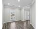 Living room with wood flooring, fresh paint, a window, and natural light at 2461 Peregrine Trl, Suwanee, GA 30024