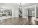 Open-concept living room with wood flooring and grey paint at 2461 Peregrine Trl, Suwanee, GA 30024