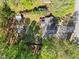 The home's aerial view showcases a fire pit, a shed, mature trees, and an expansive lawn for outdoor enjoyment at 363 Ridge Run Dr, Hiram, GA 30141