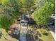 Aerial shot of the home with a long driveway, a two-car garage, mature trees, and lush lawn at 363 Ridge Run Dr, Hiram, GA 30141