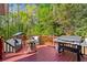 Spacious porch with outdoor seating and Blackstone grill overlooking a wooded backyard at 363 Ridge Run Dr, Hiram, GA 30141