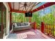 Inviting back porch with comfortable seating and view of the surrounding trees at 363 Ridge Run Dr, Hiram, GA 30141
