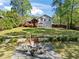 A spacious backyard with a well-maintained lawn, a cozy fire pit area, and a charming deck, perfect for outdoor gatherings at 363 Ridge Run Dr, Hiram, GA 30141