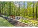 A cozy fire pit area nestled in the backyard with wooded views at 363 Ridge Run Dr, Hiram, GA 30141