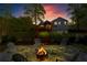 Outdoor fire pit area in backyard at twilight at 363 Ridge Run Dr, Hiram, GA 30141