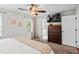 Cozy bedroom featuring a ceiling fan and adjacent bathroom entrance at 363 Ridge Run Dr, Hiram, GA 30141