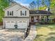 Charming two-story home boasts a well-manicured lawn, inviting front porch, and a convenient two-car garage at 363 Ridge Run Dr, Hiram, GA 30141