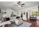 Spacious living room blends with the dining area, with a large sectional sofa, modern décor, and a view of the backyard at 363 Ridge Run Dr, Hiram, GA 30141