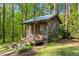 Charming log cabin nestled amongst the trees at 363 Ridge Run Dr, Hiram, GA 30141