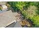 Aerial view showcasing the backyard layout, including a pergola and patio, in a green, wooded setting at 3715 Lexington Rd, Tucker, GA 30084