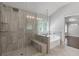 Bathroom features a tiled glass shower with a bench and a soaking tub by a shuttered window at 3715 Lexington Rd, Tucker, GA 30084