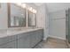 Bathroom featuring dual sinks, gray cabinets, granite counters, and glass enclosed shower at 3715 Lexington Rd, Tucker, GA 30084