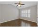 Bedroom offers wood floors, neutral walls, a window with white shutters, and a ceiling fan at 3715 Lexington Rd, Tucker, GA 30084