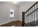 View of the entryway with wood floors, staircase, and a white door with lattice window at 3715 Lexington Rd, Tucker, GA 30084