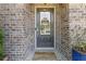 Front door of brick home, featuring a 'welcome' mat and a 'hello' sign at 3715 Lexington Rd, Tucker, GA 30084