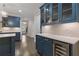 Kitchen boasts blue cabinets, hardwood floors, wine fridge, and white countertops at 3715 Lexington Rd, Tucker, GA 30084