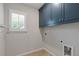 Laundry room featuring blue cabinets for storage and a window providing natural light at 3715 Lexington Rd, Tucker, GA 30084
