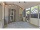 Charming screened patio featuring stone floors, ceiling fan, and string lights for enjoyable outdoor living at 3715 Lexington Rd, Tucker, GA 30084