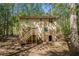 Exterior view of the home showcasing a wooden deck and private, wooded lot at 464 Meadowbrook Dr, Mcdonough, GA 30253