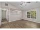 The primary bedroom has wood-look flooring, a ceiling fan, and natural light at 464 Meadowbrook Dr, Mcdonough, GA 30253