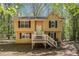 Charming home featuring a quaint front porch, classic shutters, and a private wooded lot at 464 Meadowbrook Dr, Mcdonough, GA 30253