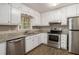 The kitchen is equipped with stainless steel appliances, countertops, and cabinets at 464 Meadowbrook Dr, Mcdonough, GA 30253
